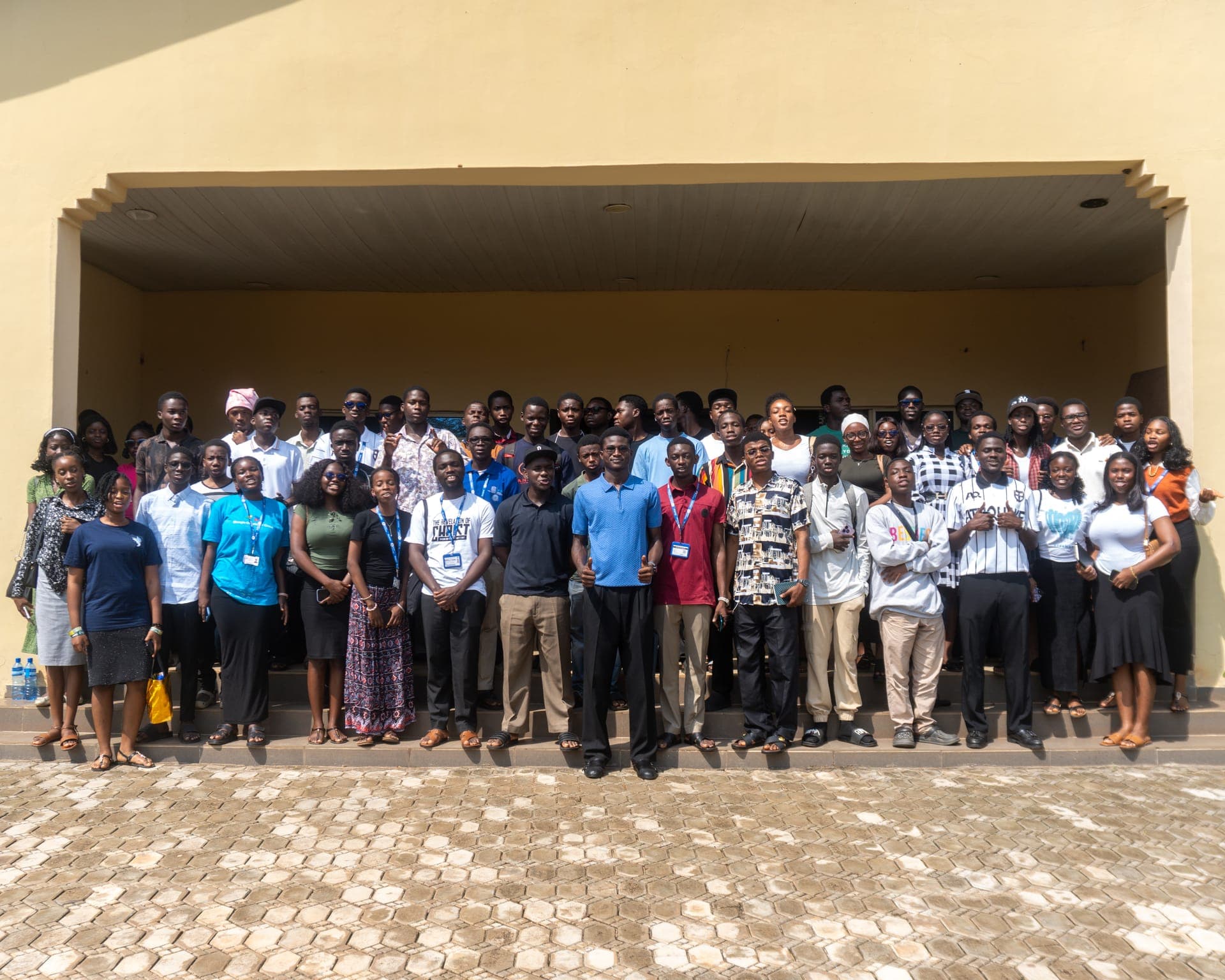 Group photo of event attendees outside a university building