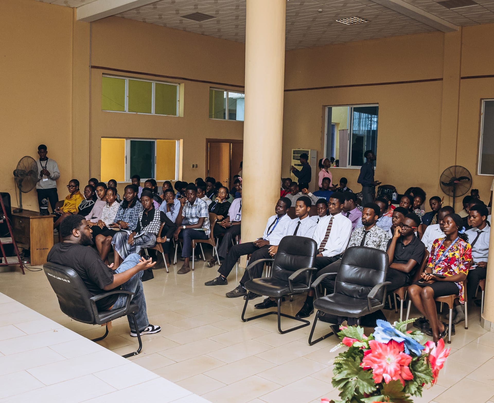 Students seated in a hall during a fireside session
